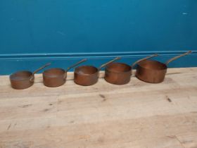 Set of five graduated copper saucepans with wrought iron handles. {20 cm H 42 cm W x 21 cm D} to {14