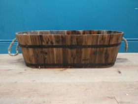 Stained pine and metal bound planter. {25 cm H x 80 cm W x 33 cm D}.