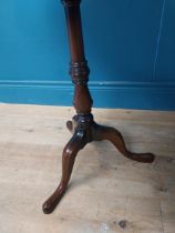 Mahogany lamp table raised on turned column and three outswept legs in the Regency style {64 cm H