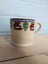 Rare 19th. C. spongeware mug decorated with knights & shields { 10cm H X 12cm W }.