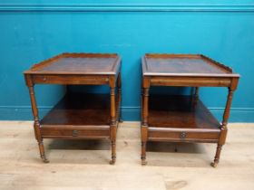 Pair of burr walnut lamp tables with gallery back raised on turned columns and brass castors {67
