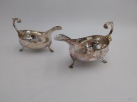 Pair of Irish silver sauce boats, plain oval form, leaf capped scroll handles, scalloped rims,