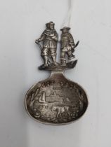 German silver tea caddy spoon , the bowl decorated with village scene with an oxen in the fore