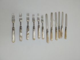 Set of six silver bladed knife and fork set with the cuffs decorated with scrolls and shields and
