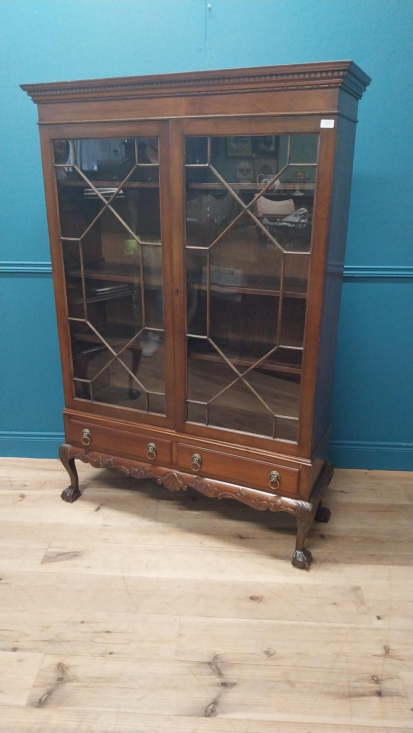 Good quality Edwardian mahogany display cabinet on stand with two astral glazed doors above two