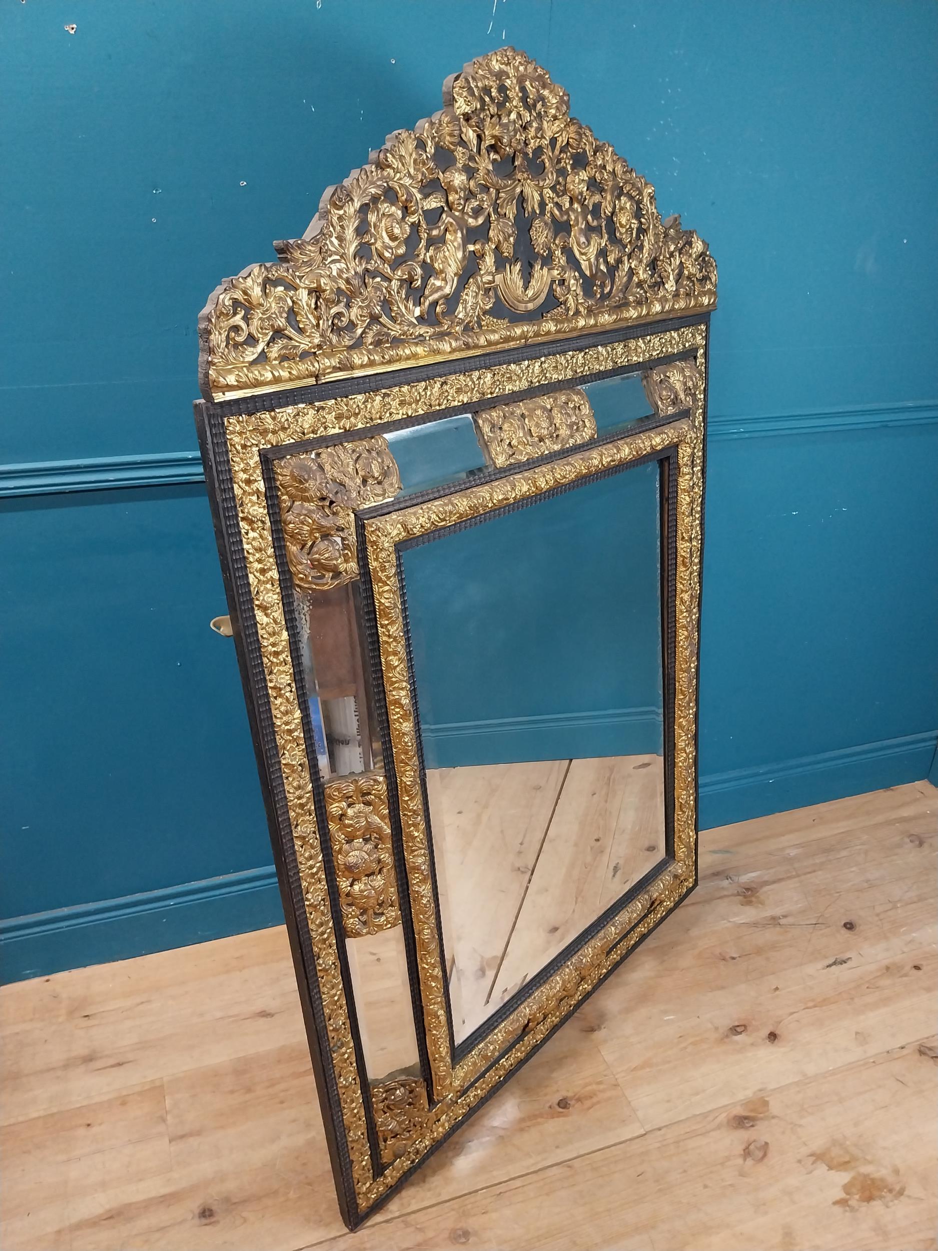 19th C. French brass and ebonised cushion mirror surmounted with cherub and flora and foliage - Image 5 of 8