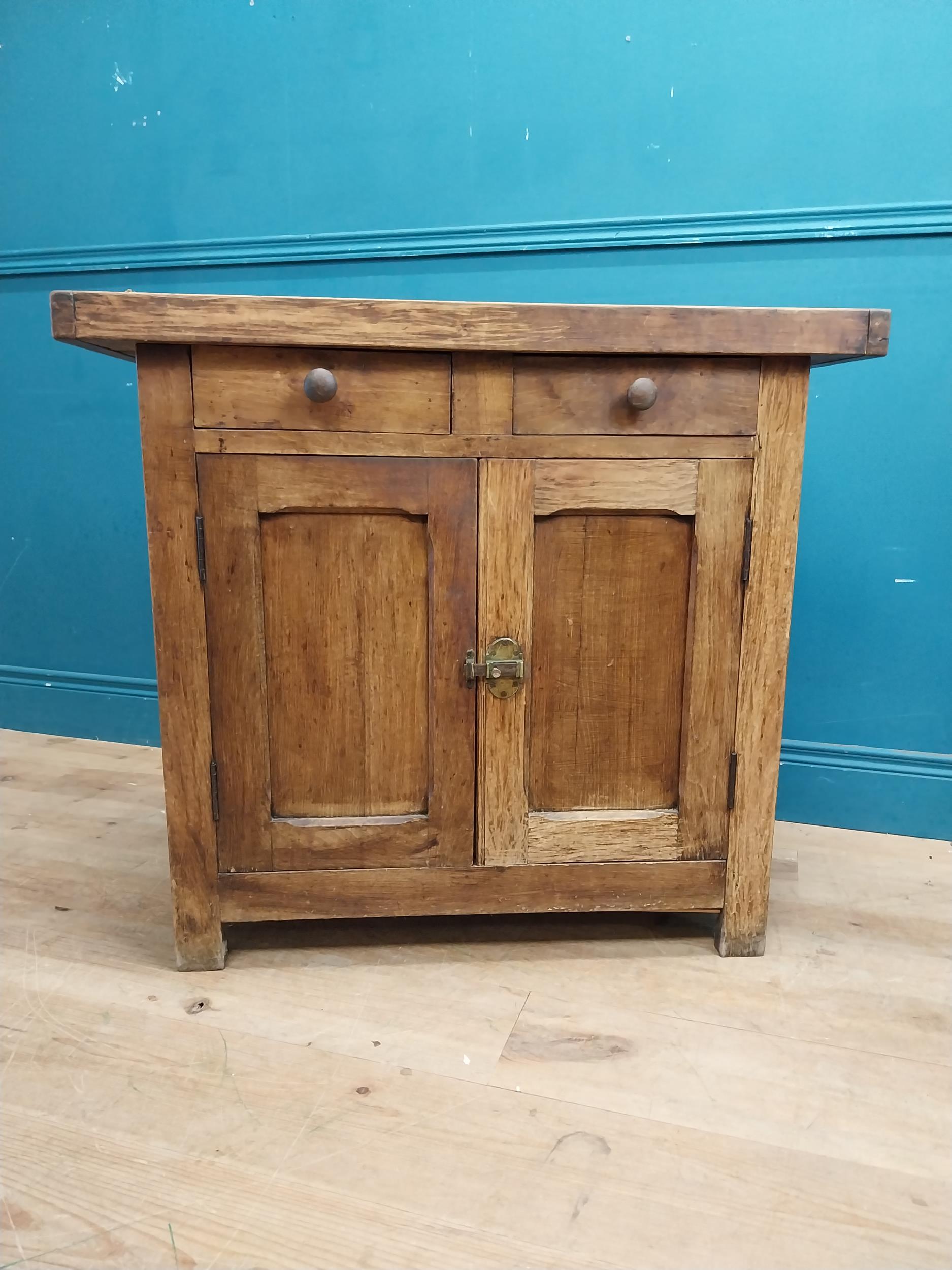 Early 20th C. oak and pine cupboard with two long doors over two short drawers on square feet. {80 - Image 3 of 9