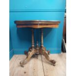 19th C. walnut turn over leaf card table raised on turned columns, four carved outwept feet and
