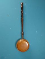 Early 20th C. copper bed warmer with turned wooden handle. {82 cm H x 21 cm W 6 cm D}.