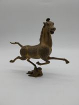 Brass model of Flying Horse of Gansu. {21 cm H x 25 cm W x 7 cm D}.
