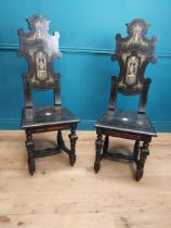Pair of Aesthetic Movement ebonised hall chairs with inlaid bone decoration of Grecian imagery. {126