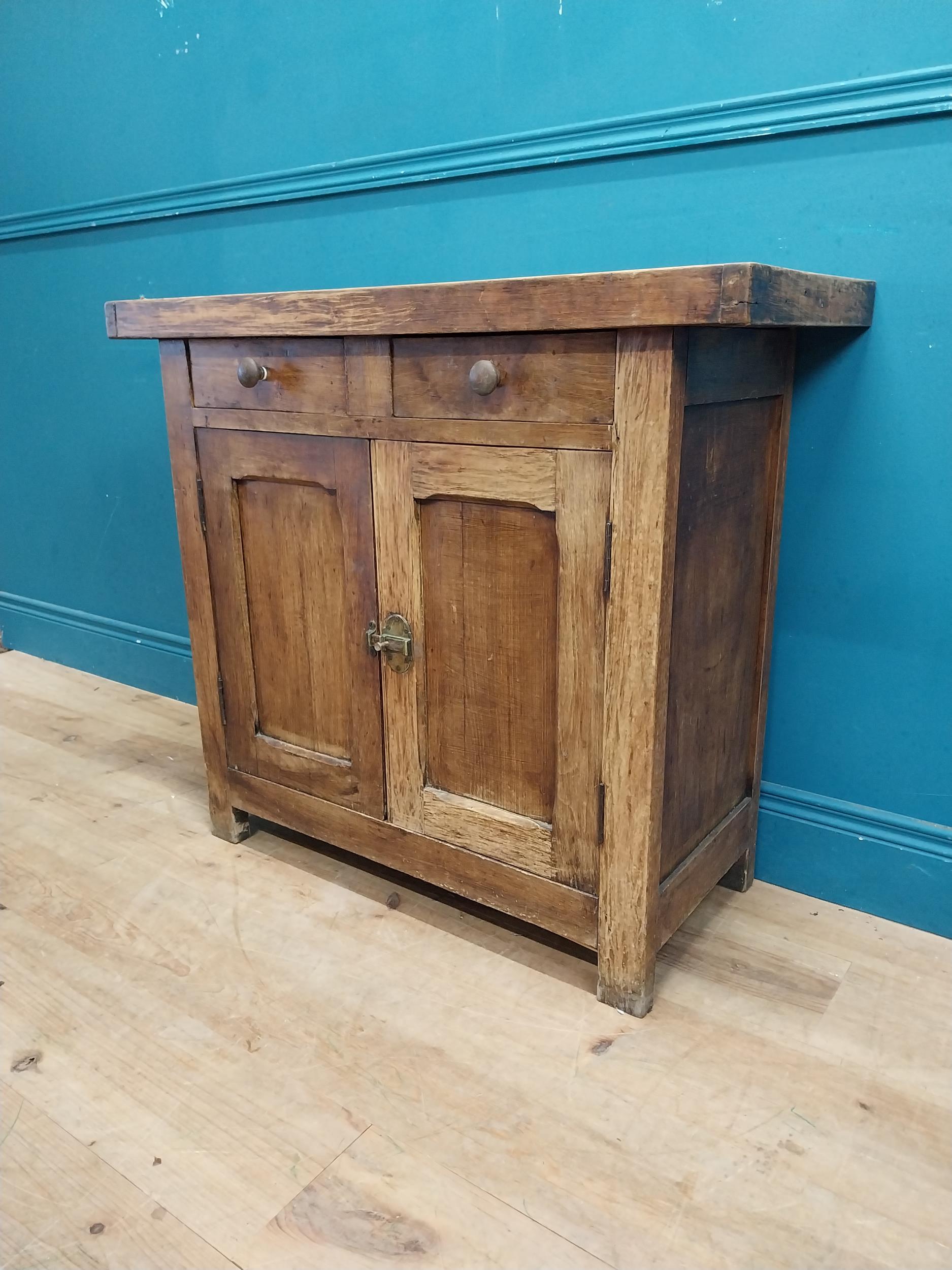 Early 20th C. oak and pine cupboard with two long doors over two short drawers on square feet. {80 - Image 9 of 9