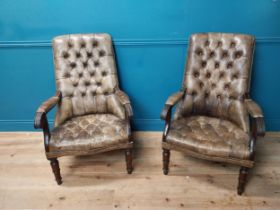 Pair of good quality deep buttoned leather upholstered library chairs on turned tapered legs. {108