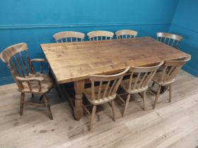 Pine kitchen table on four turned legs with double stretcher and six plus two matching chairs. {80