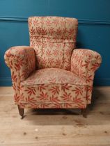 19th C. upholstered armchair raised on tapered legs and castors {101 cm H x 80 cm W x 80 cm D}.