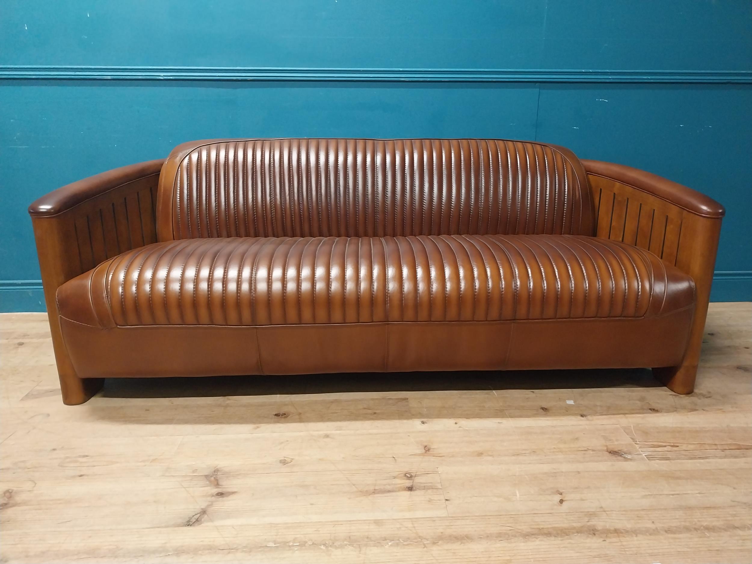 Exceptional quality hand dyed leather and cherrywood Aviator sofa. {}