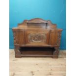 19th. C. heavily carved oak side board with gallery back and three central drawers raised on