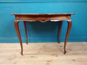 Edwardian mahogany and brass inlaid centre table on shaped legs. {73 cm H x 100 cm W x 58 cm D}.