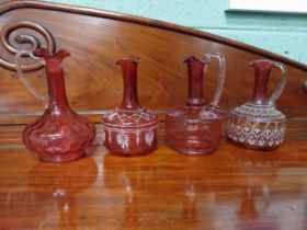 Four 19th C. ruby glass jugs. {22 cm H}.