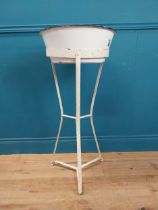 Edwardian enamel basin on wrought iron tripod stand. {90 cm H x 40 cm Dia. }.