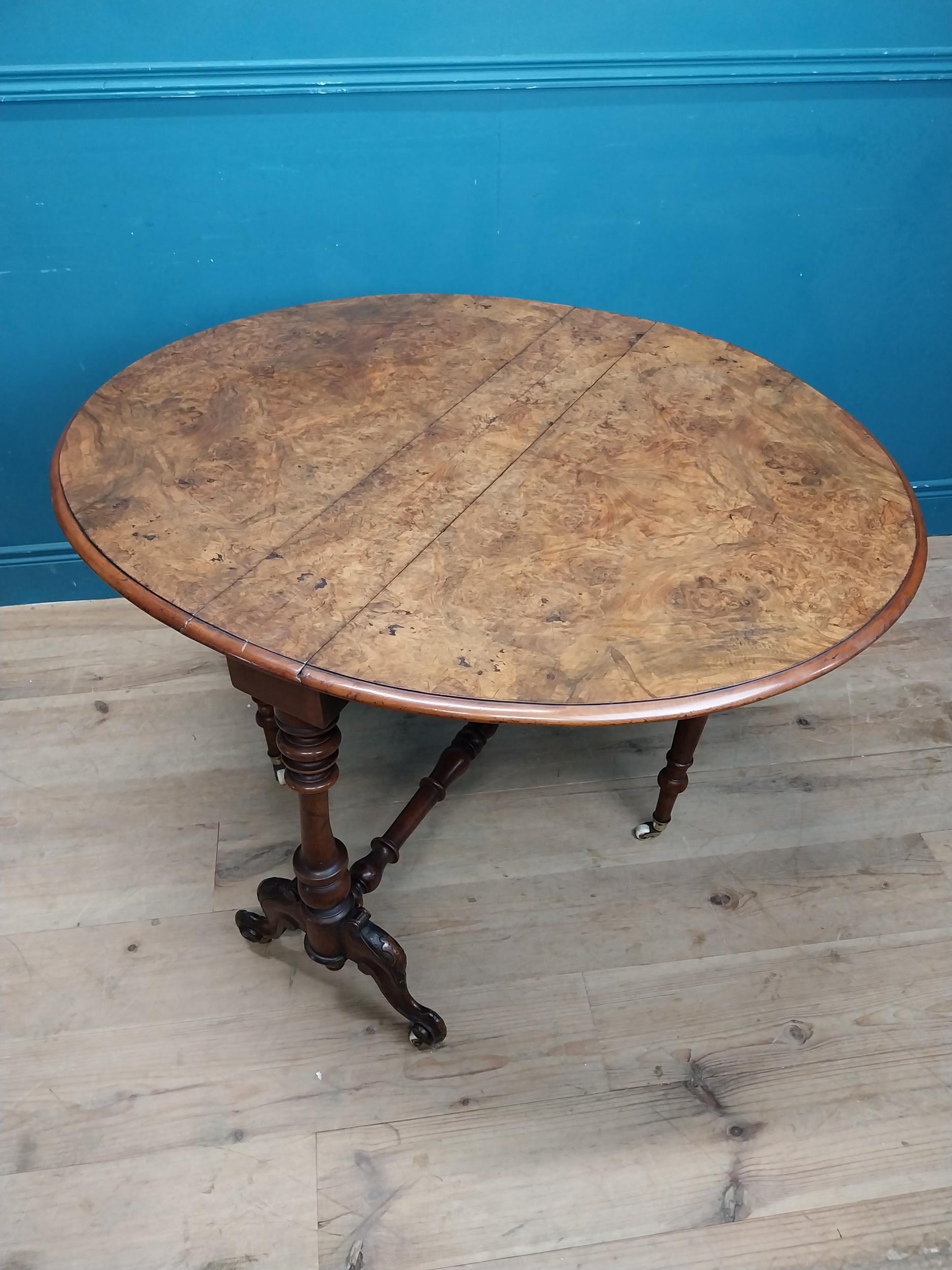 19th C. burr walnut Sutherland table with turned legs raised on arched feet with castors. {73 cm H x - Image 6 of 7