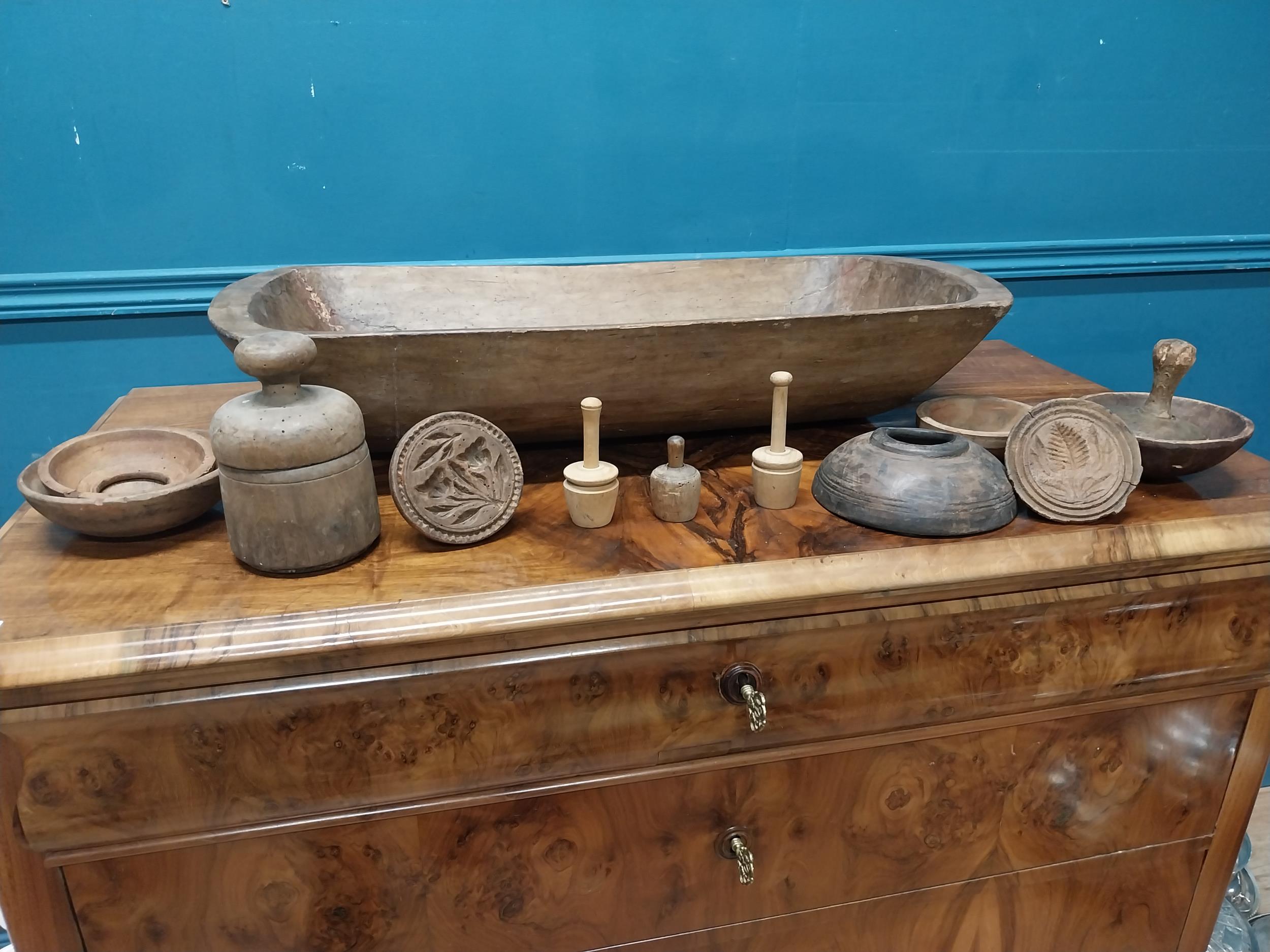 19th C. wooden dough trough and collection of butter stamps. {18 cm H x 75 cm W x 35 cm D}.