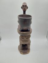 Carved hardwood African drinking vessel on stand. {60 cm H x 16 cm W x 18 cm D}.