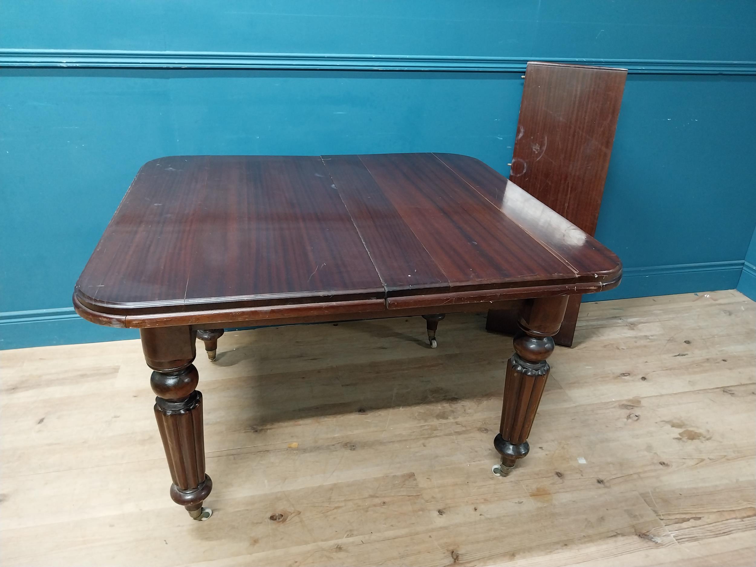 Victorian mahogany dining room table with one extra leaf raised on turned legs and brass and castors - Image 2 of 5