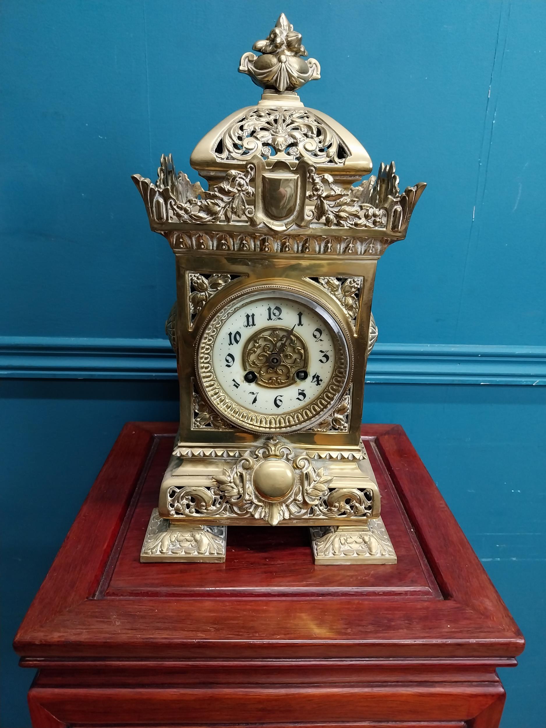 Decorative brass mantle clock in the Victorian style {39 cm H x 19 cm W x 19 cm D}.