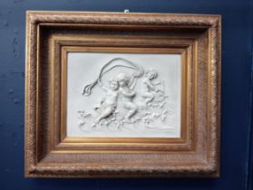 Marble plaque depicting cherubs and fish mounted in gilt frame {H 57cm x W 67cm x D 8cm }.