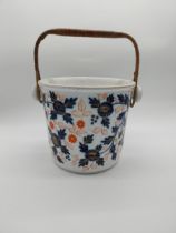 19th C. ceramic pot with wicker handle. {37 cm H x 32 cm W x 26 cm D}.