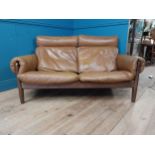 Mid Century rosewood and leather two seater sofa {83 cm H x 140 cm W x 90 cm D}.