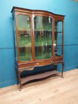 Edwardian mahogany glazed display cabinet with single drawer in frieze raised on cabriole legs. {177