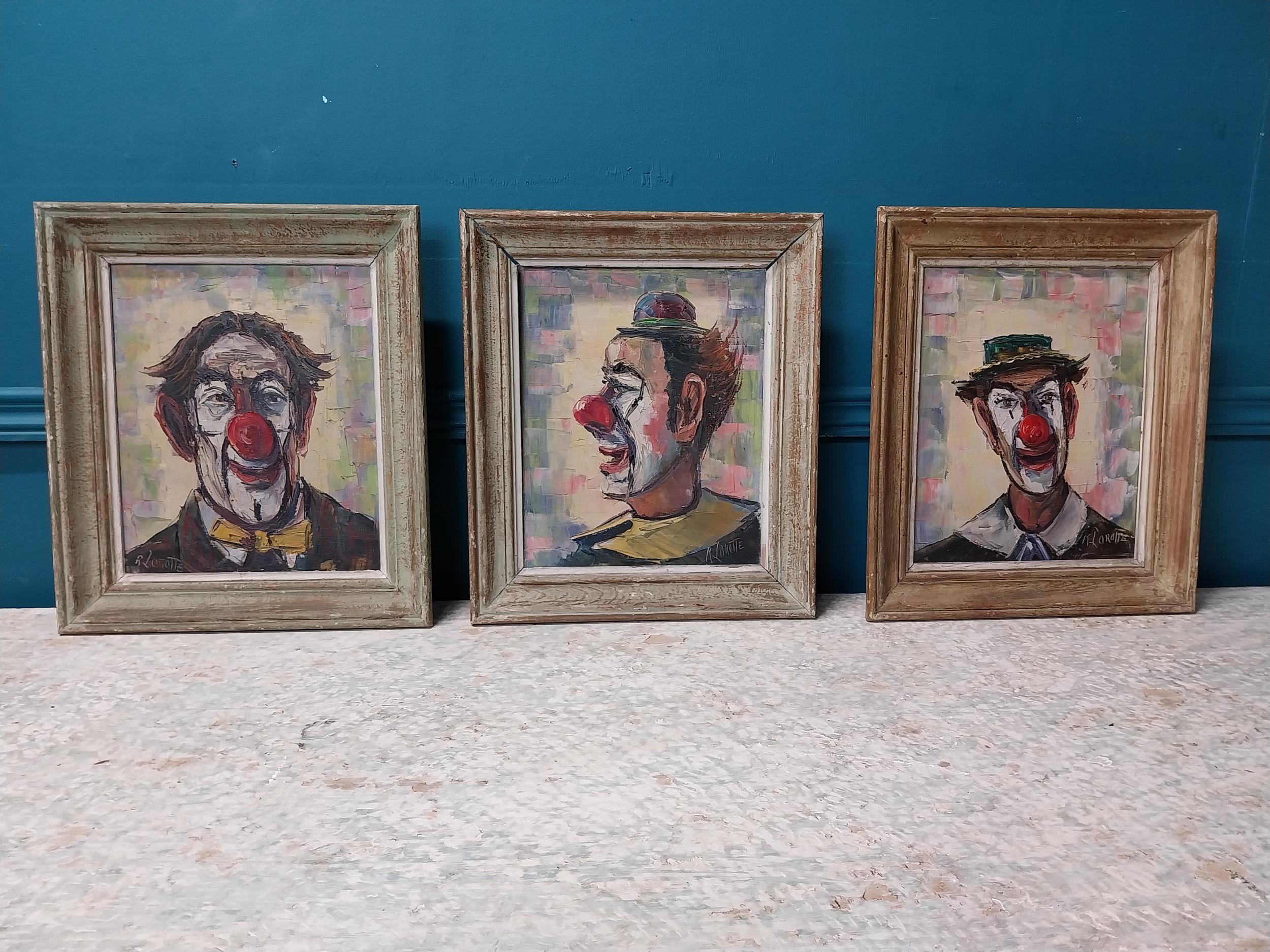 Set of three early 20th C. Clown oil on boards mounted in wooden frames {35 cm H x 30 cm W}.