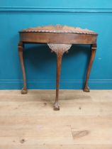 1950's mahogany demi lune table with carved frieze on the claw and ball feet. {83 cm H x 90 cm W x