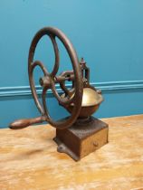 Early 20th C. cast iron and brass wheel coffee grinder {50 cm H x 40 cm W x 34 cm D}.