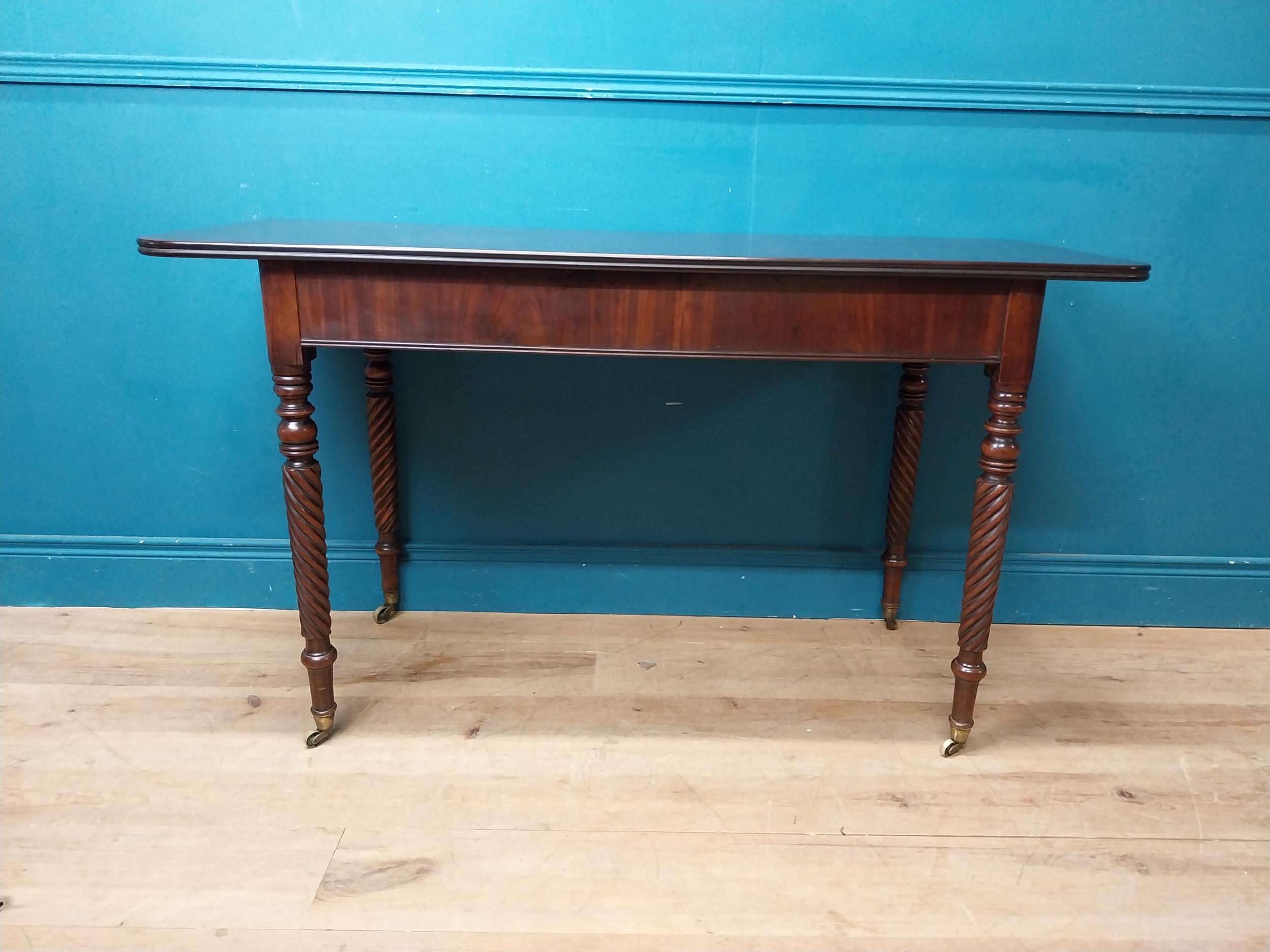 Regency mahogany side table raised on four turned legs. {74 cm H x 132 cm W x 52 cm W}.