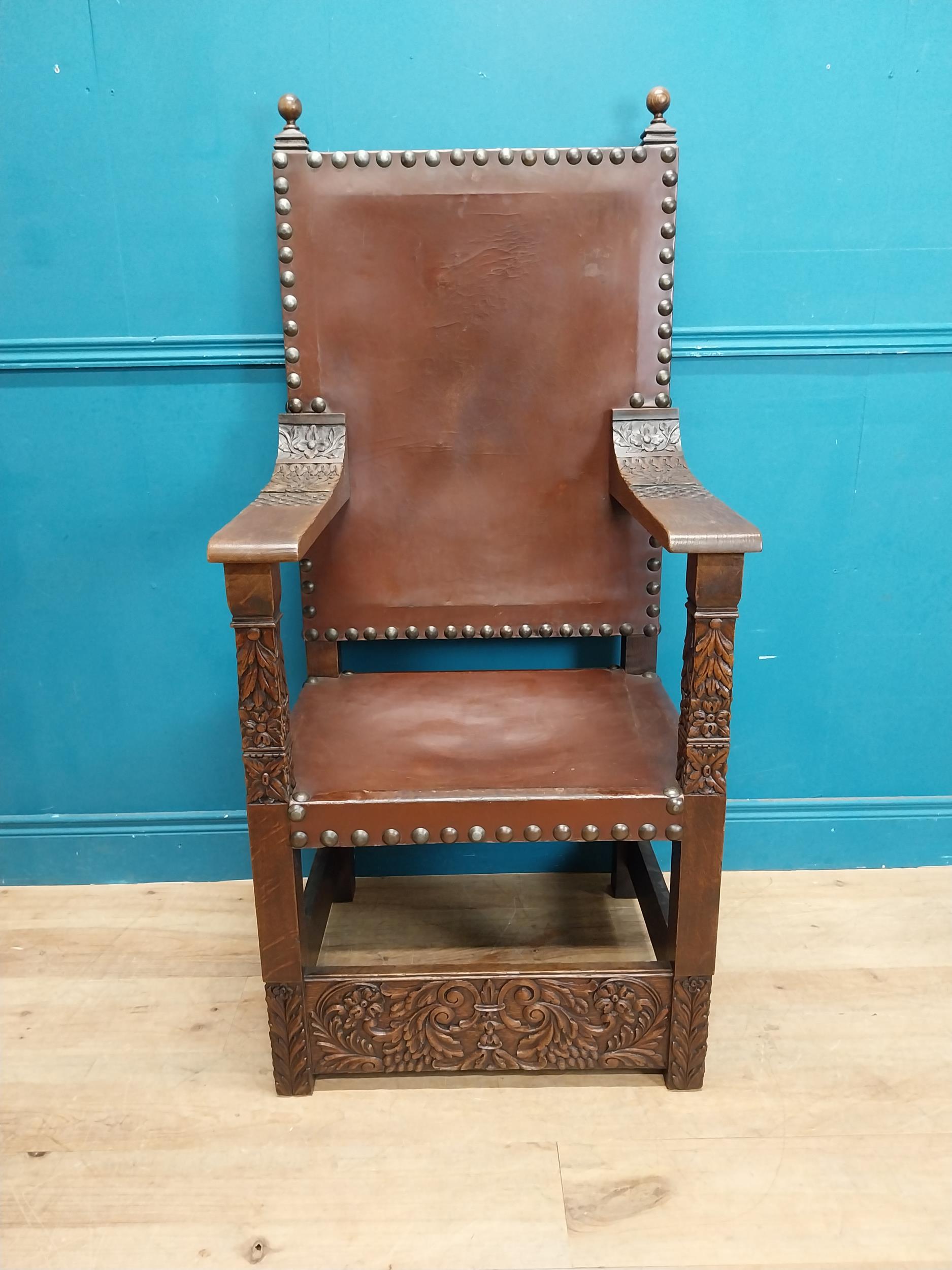 Edwardian carved oak and leather upholstered throne chair. {165 cm H x 63 cm W x 55 cm D}.