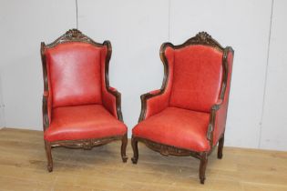 Pair of leather upholstered wingback armchairs in Italian style {H 124cm x W 77cm x D 54cm}.