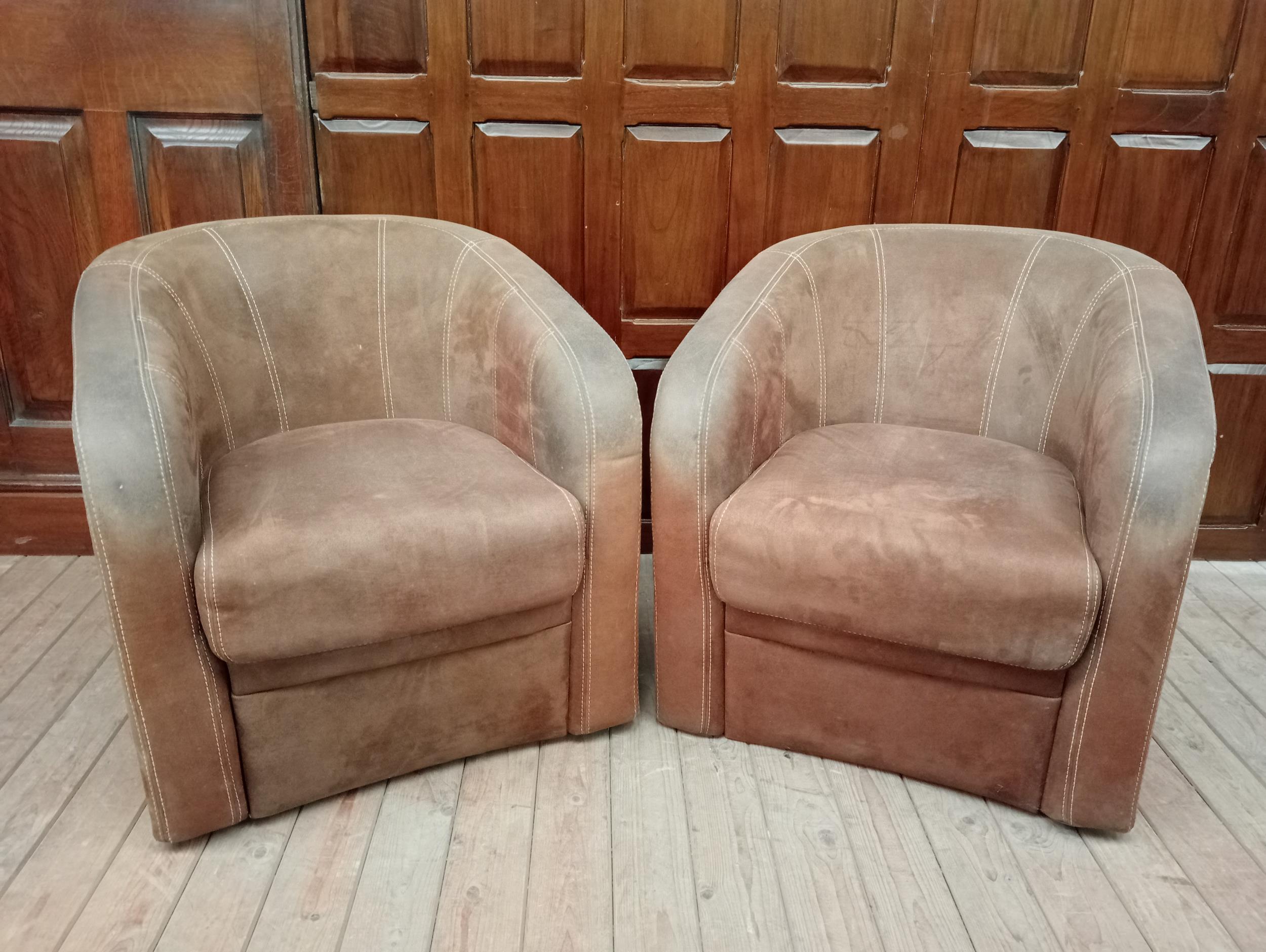 Pair of tanned leather tub chairs {H 76cm x W 73cm x D 80cm }.