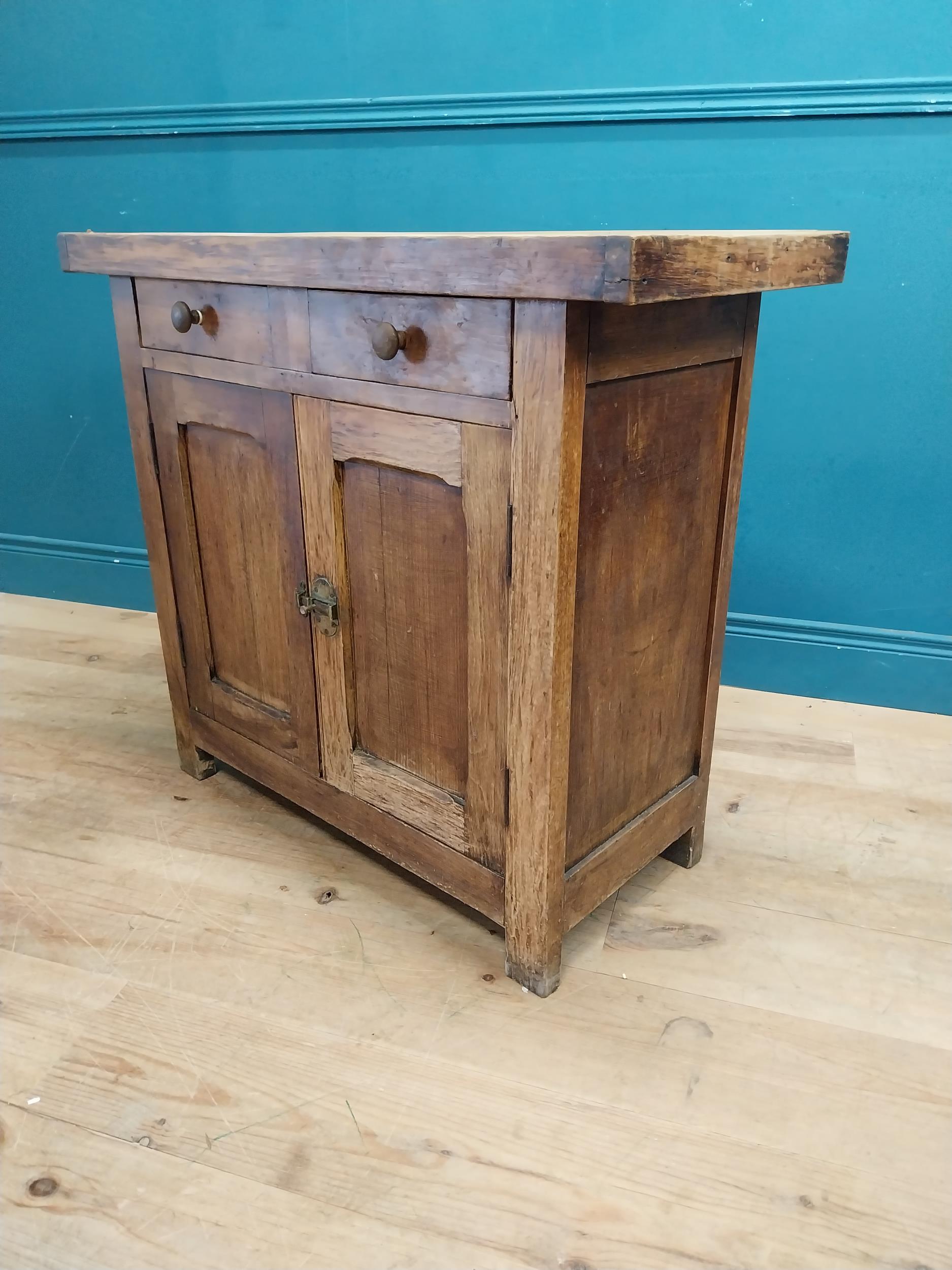 Early 20th C. oak and pine cupboard with two long doors over two short drawers on square feet. {80 - Image 6 of 9