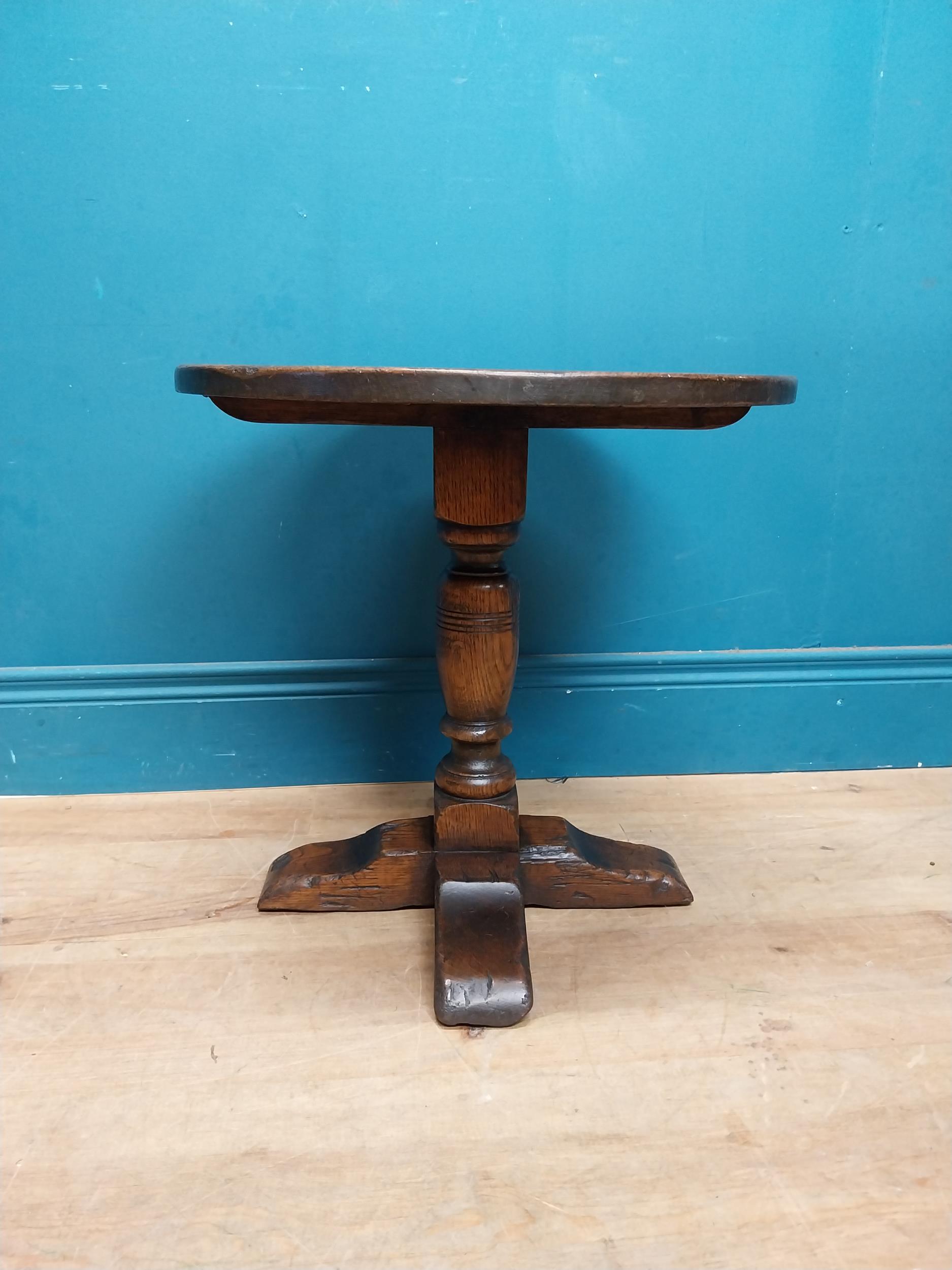 Oak wine table on turned column with four outswept shaped feet. {45 cm H x 45 cm Dia.}.