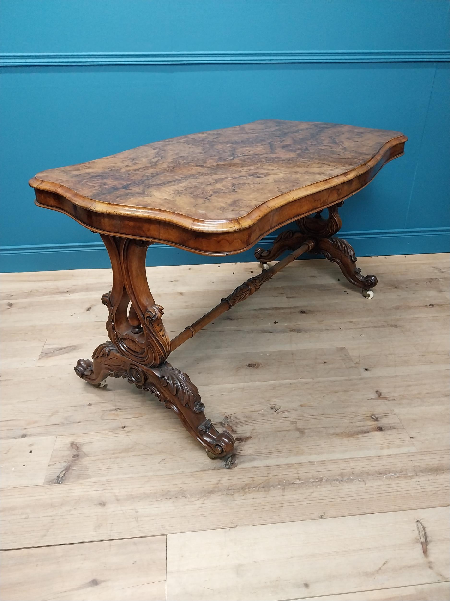 19th C. burr walnut sofa table raised on lyre supports and four outswept legs on turned stretcher {