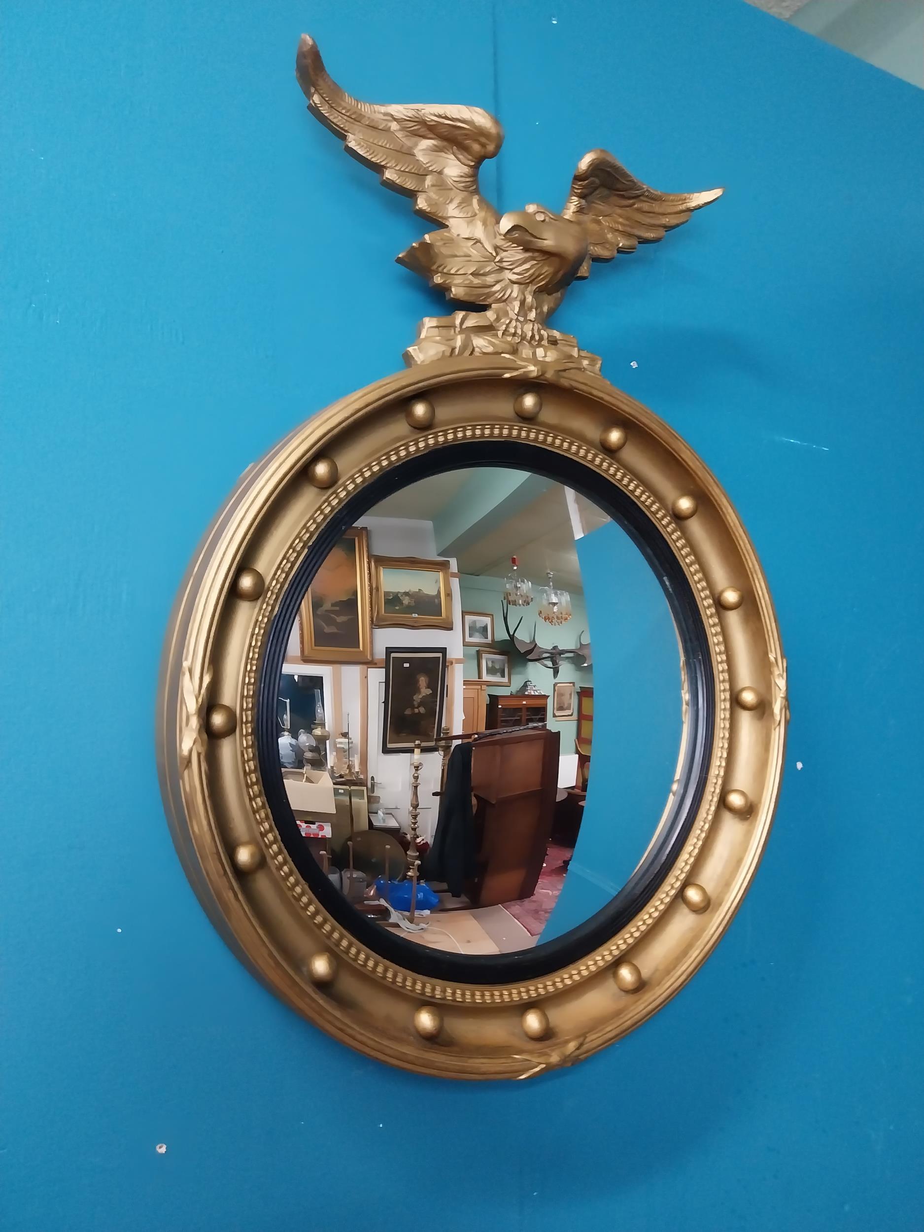 Victorian giltwood convex mirror surmounted by eagle. {63 cm H x 47 cm W}.