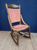Teak and upholstered rocking chair {}.