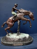 Bronze model of a horse and jockey mounted on marble base {H 43cm x W 36cm x D 22cm }.