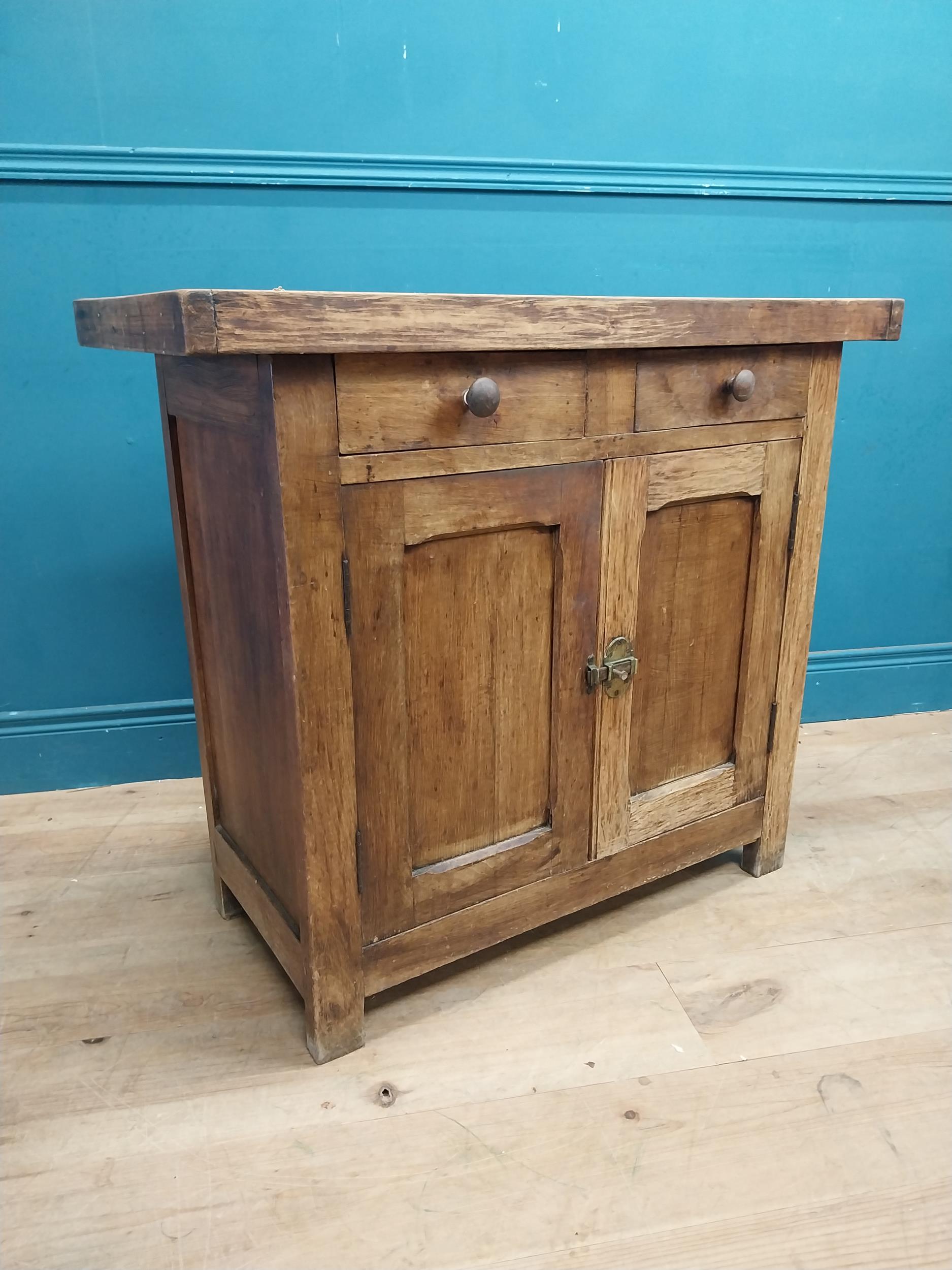 Early 20th C. oak and pine cupboard with two long doors over two short drawers on square feet. {80