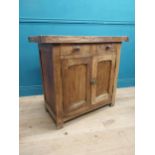 Early 20th C. oak and pine cupboard with two long doors over two short drawers on square feet. {80