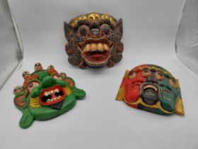 Three hand carved and painted Tribal masks. {26 cm H x 23 cm W} and {25 cm H x 27 cm W}.