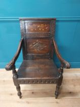 19th C. oak throne chair raised on turned legs with arms terminating in scroll detail and inlaid
